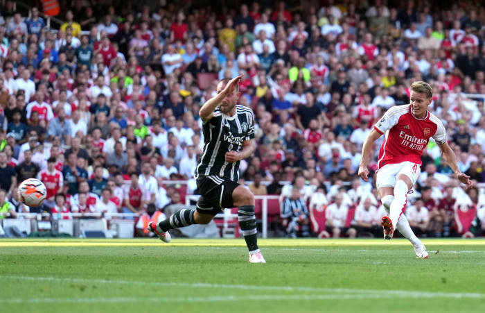 Arsenal captain Martin Odegaard pictured (right) scoring against Manchester United in September 2023